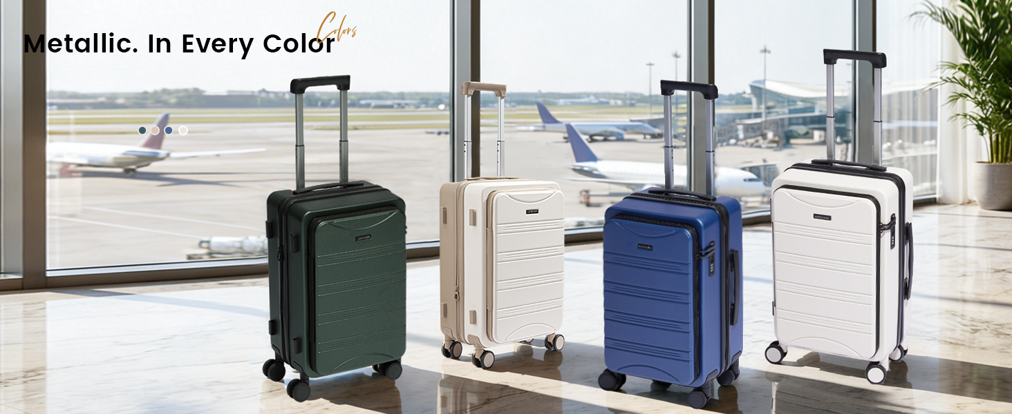 Assorted colored hard-shell carry-on luggage in an airport terminal.